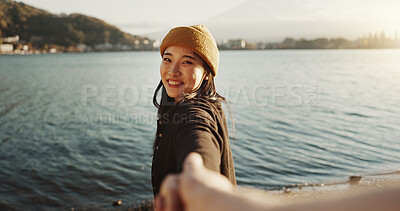 Buy stock photo Smile, leading and Japanese woman holding hands on lake for travel, trip or journey in Tokyo nature. Portrait, love and couple walking together by water for romance, date or tourism at Mount Fuji