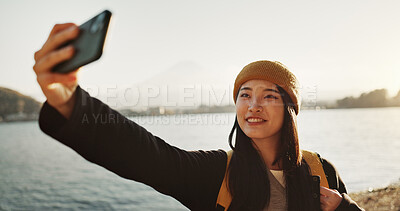 Buy stock photo Selfie, mountain and Japanese woman at ocean for holiday, vacation and happy adventure in Japan. Smile, sea and girl at Mount Fuji for digital photography, social media and live stream on travel blog
