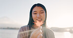 Japanese woman, maple leaf and lake for smile, thinking or memory in nature, adventure or holiday in sunrise. Girl, plant and happy for holiday by water, environment or outdoor with sunshine in Tokyo