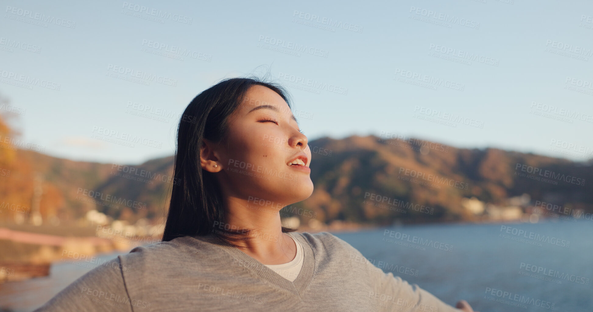 Buy stock photo Japanese woman, freedom and peace outdoor, lake or ocean with travel, holiday and mindfulness in nature. Wellness, adventure and care free at beach in Japan, happy with breathing and positivity