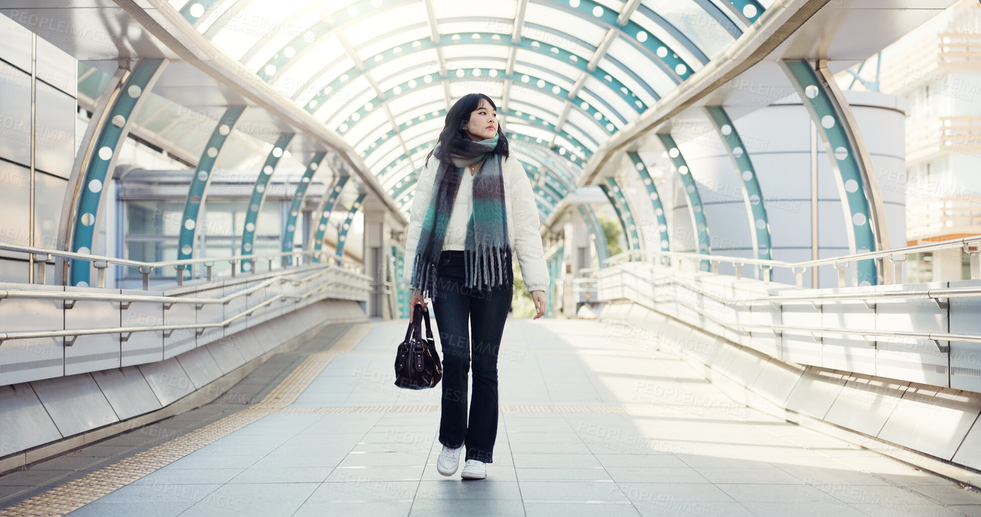 Buy stock photo Bridge, thinking and Japanese woman in city on commute, travel and journey in metro. Walking, fashion and person with trendy clothes, casual style and bag for adventure, holiday and vacation in town