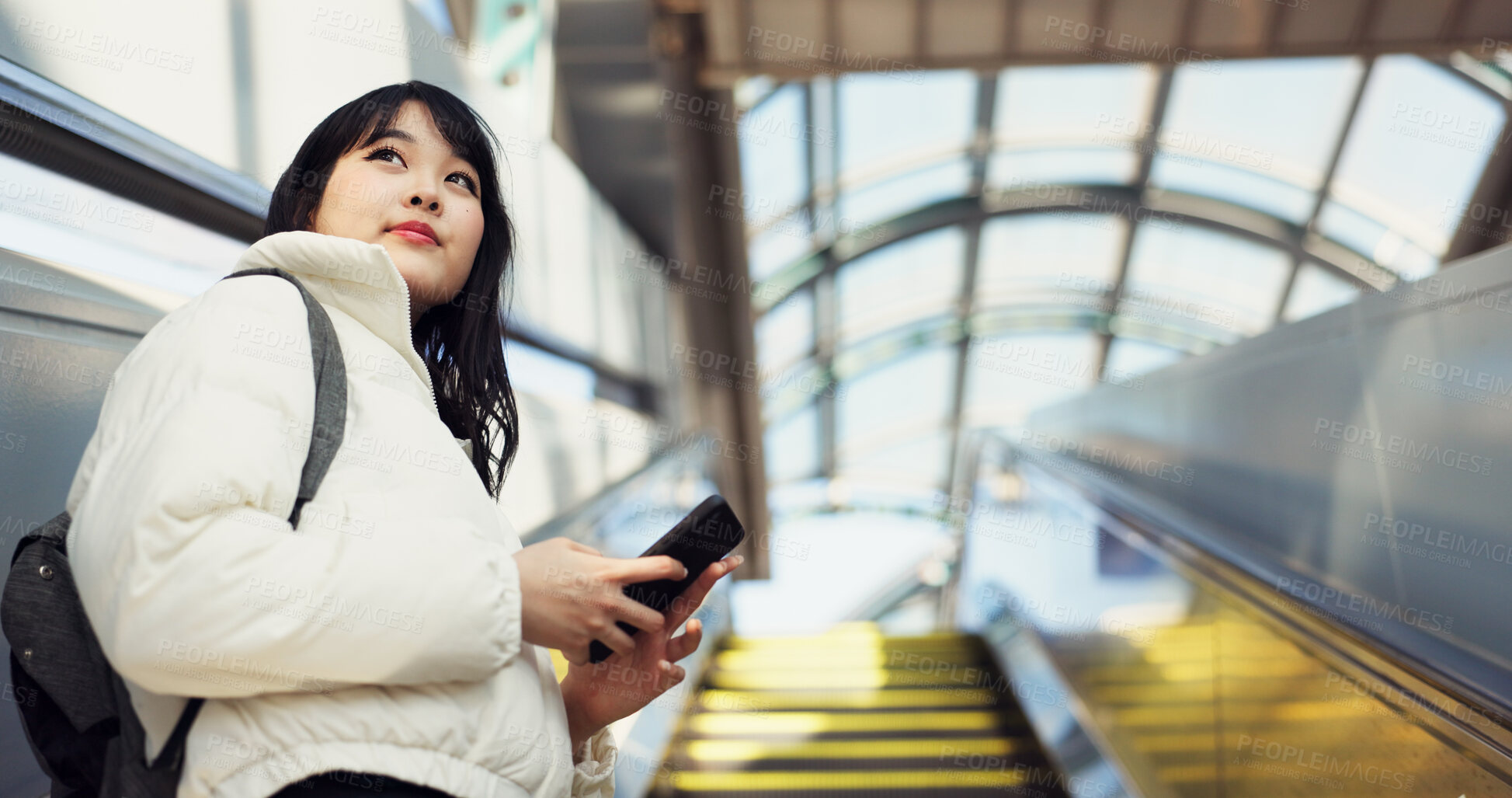 Buy stock photo Woman, stairs and smartphone for commute, texting and japanese on social media app. Technology, communication and text message for digital, internet and chatting with backpack, travel and escaltor