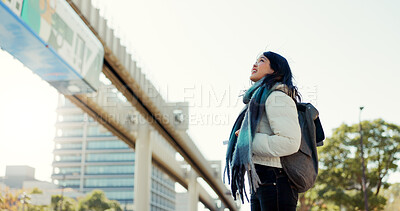 Japanese, woman and happy in city with travel in nature for morning commute, sightseeing or tourism. Person, smile and backpack in Tokyo for holiday, vacation or adventure outdoor in urban town