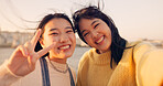 Women, friends and selfie at sea holiday in Japan for travel experience, adventure or happy. Female people, peace sign and face for city tour trip or online connection for summer, social or vacation