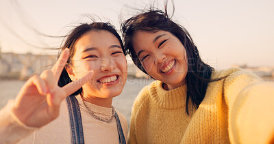 Women, friends and selfie at sea holiday in Japan for travel experience, adventure or happy. Female people, peace sign and face for city tour trip or online connection for summer, social or vacation