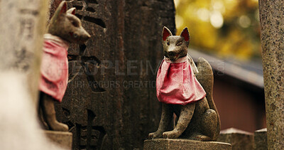 Fox statue at Shinto shrine in forest with spiritual history, Japanese culture and vintage art in nature. Travel, landmark and stone jinja sculpture in woods with stone animal monument, trees and god