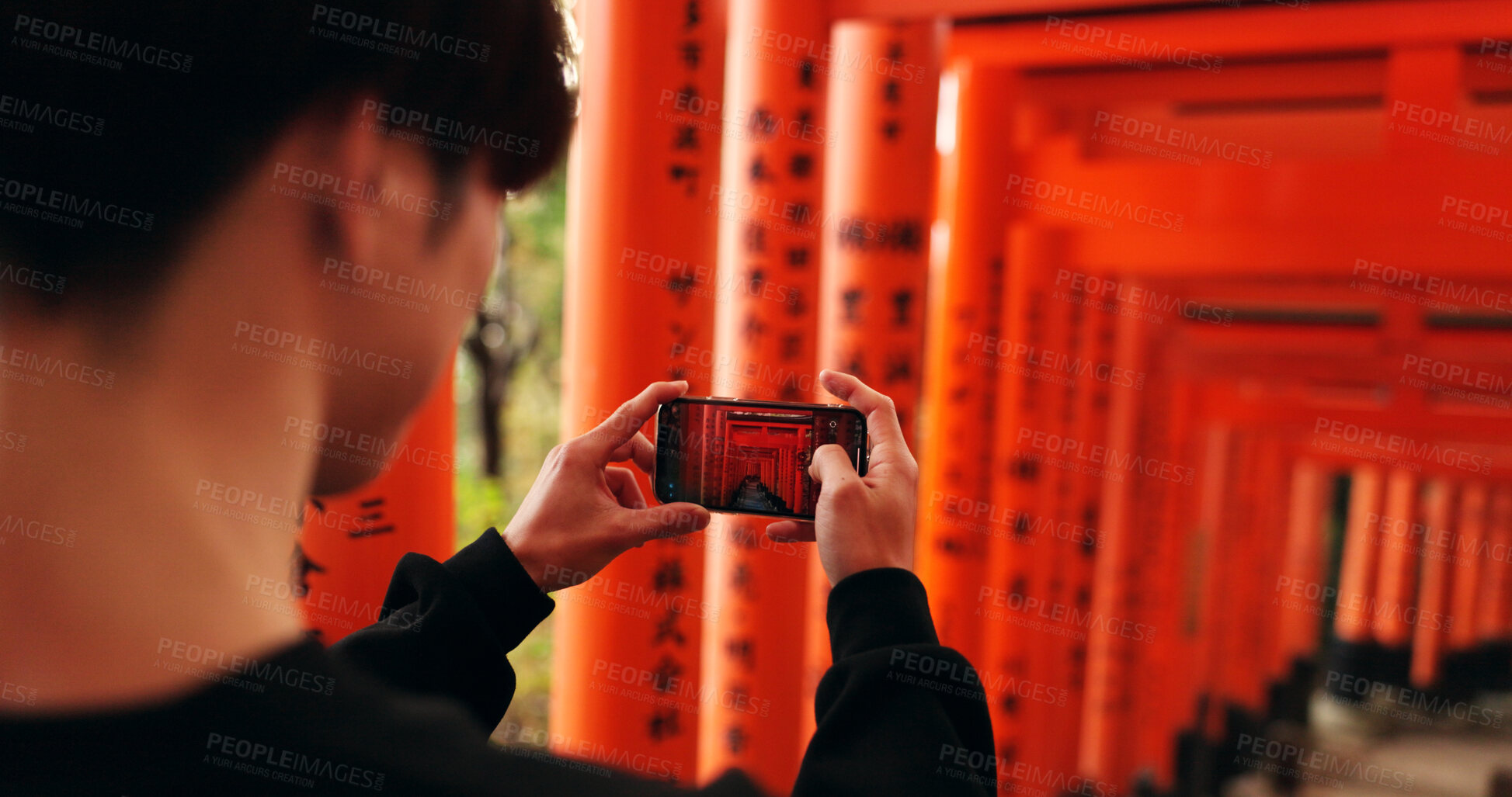 Buy stock photo Phone, man and picture of torii gates on vacation, holiday trip or travel for tourism. Smartphone, hands and closeup photography of Fushimi inari-taisha in Kyoto Japan on mobile technology outdoor