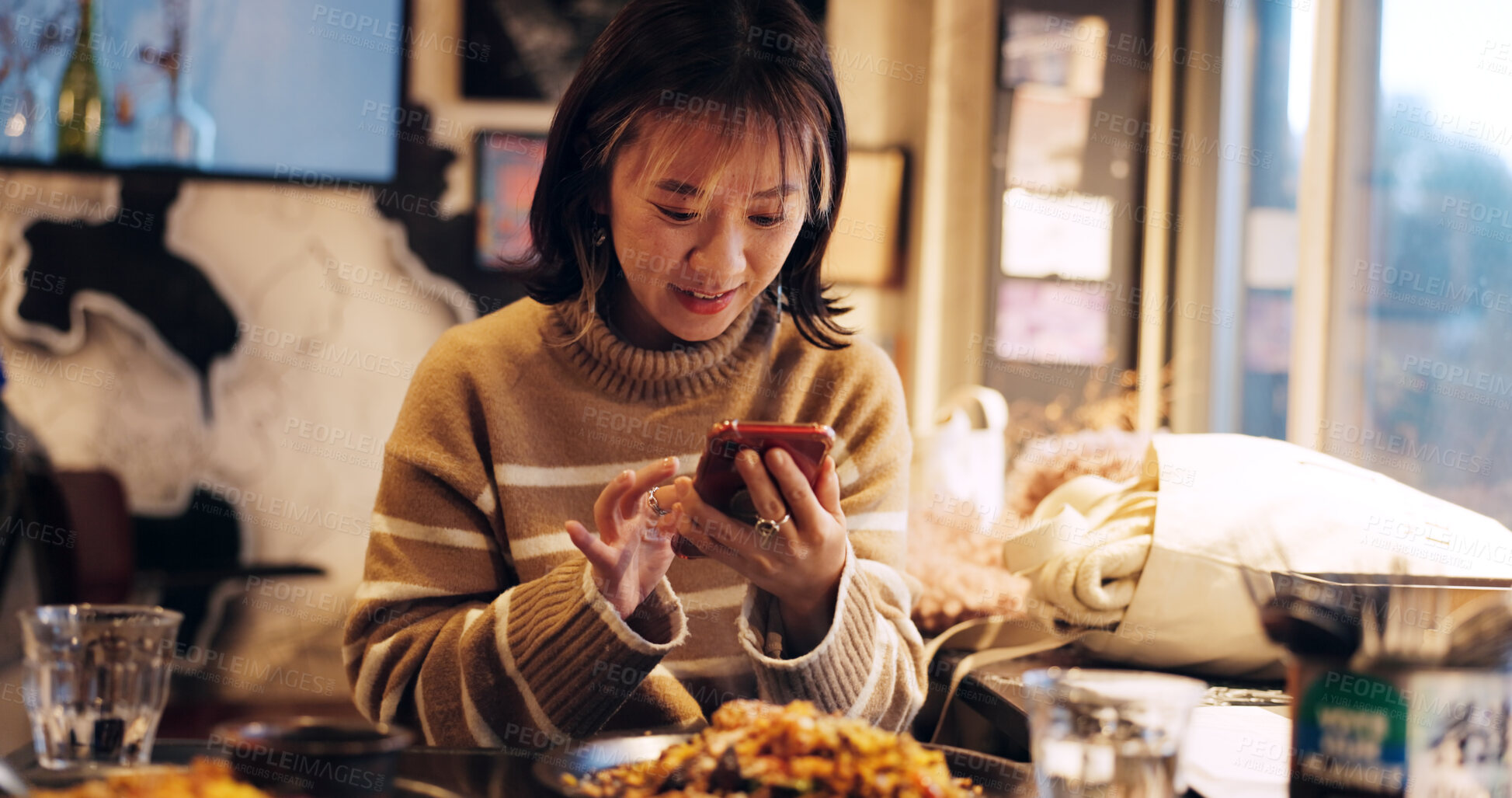 Buy stock photo Japanese woman, smartphone and healthy food in restaurant for dinner, nutrition and happy on social media. Person, mobile phone or lunch in tokyo city with umami flavor or vegetarian dish on vacation