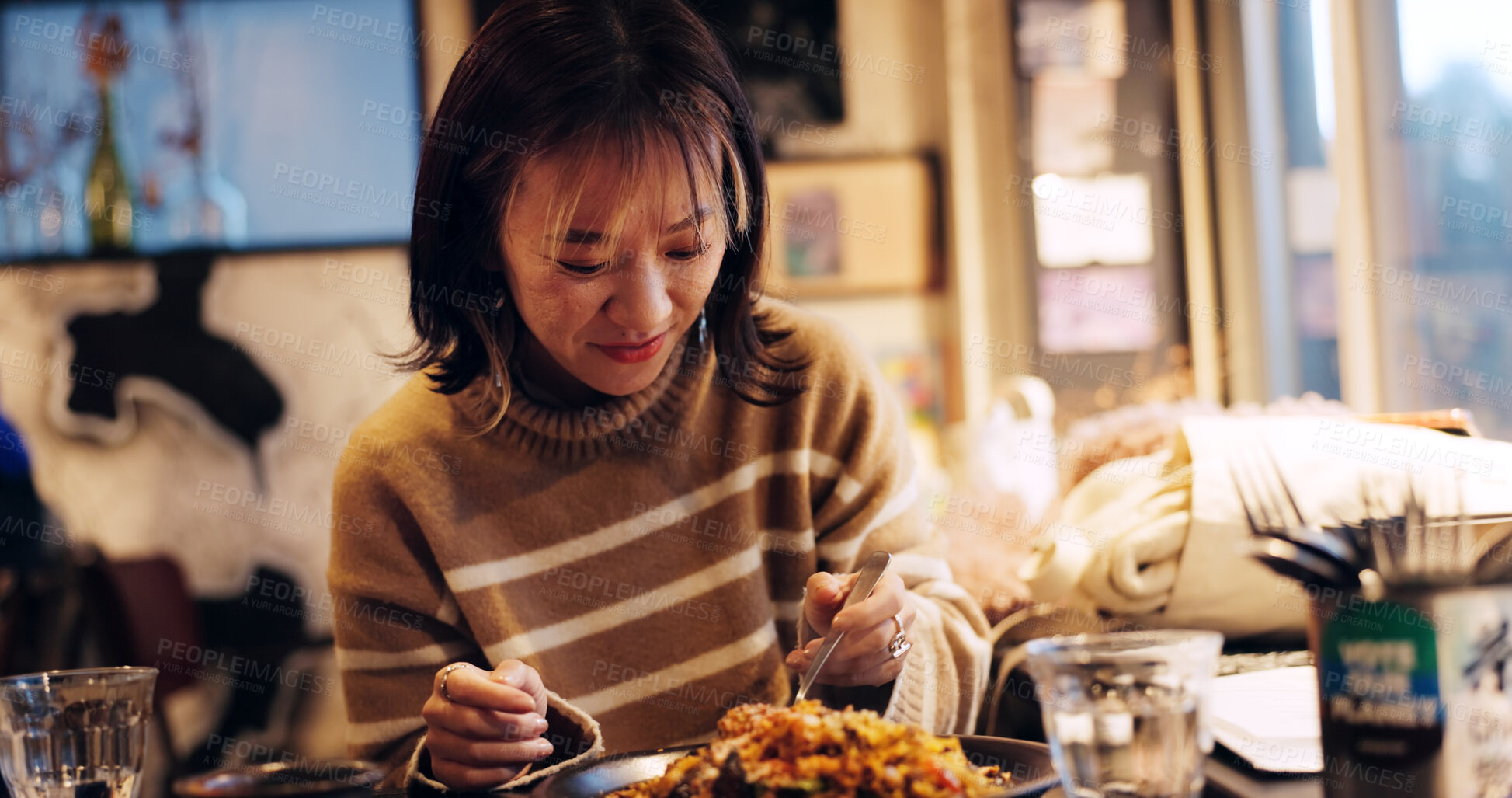 Buy stock photo Japanese woman, happy and healthy food in restaurant for dinner, nutrition and thanks bow eat meal with bow. Person, spoon and vegetarian lunch in tokyo city with wellness and gratitude on vacation