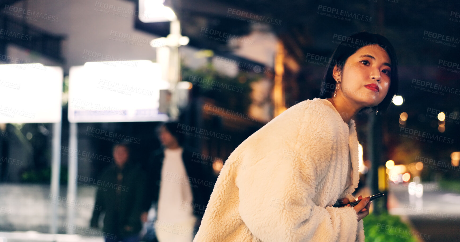 Buy stock photo Japanese woman, taxi and smartphone at night for location, city street and looking for transport. Person, waiting and cab search with cellphone app for travel, road and tokyo town with technology