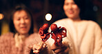 Women, Japan and travel street food at night for octopus delicacy, culture or traditional. Female people, snack and stick for tourism eating experience or cuisine in town for taste, dinner or holiday