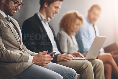 Buy stock photo Shot of a group of businesspeople waiting in line for a job interview