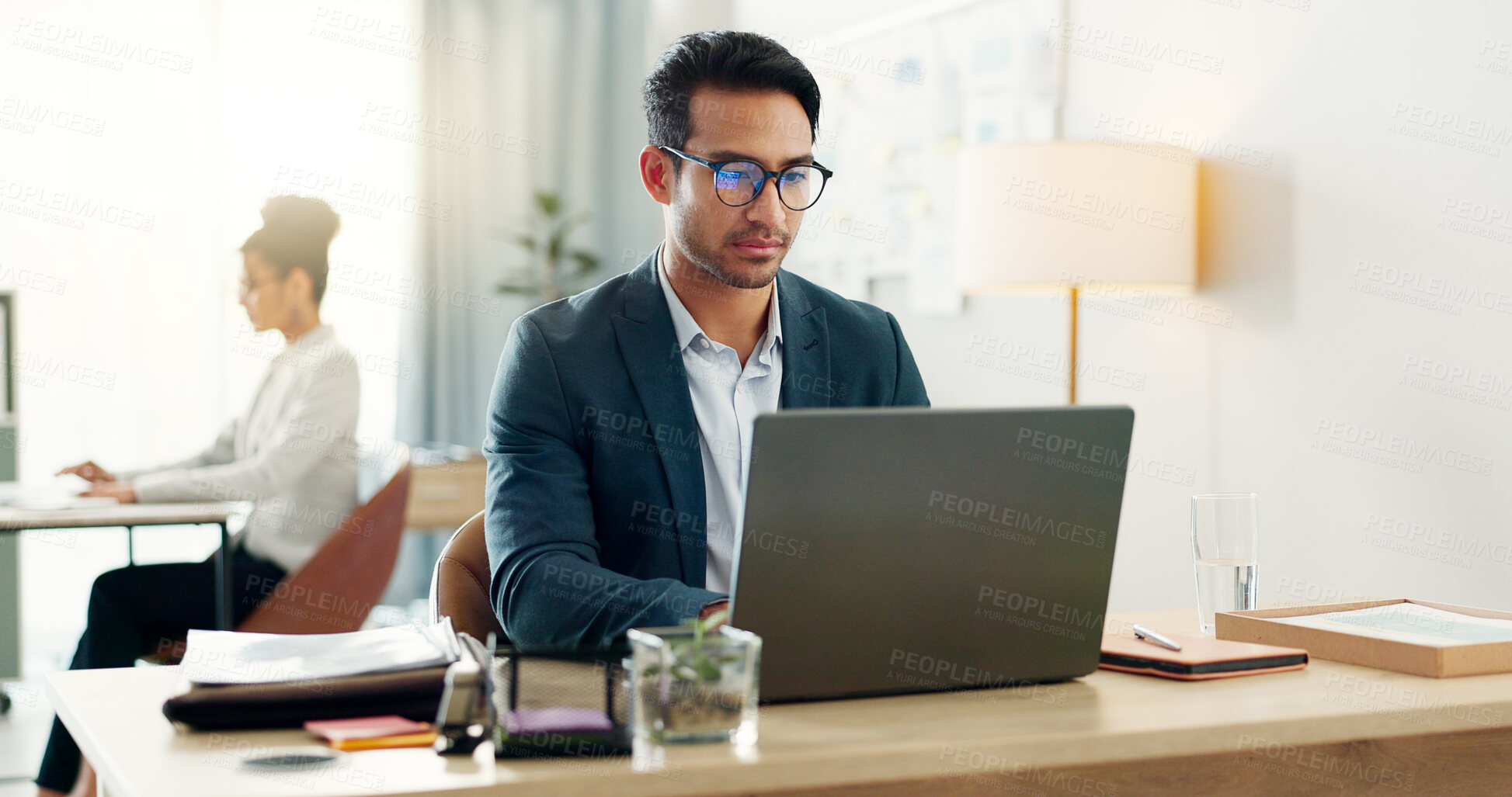 Buy stock photo Man in office with laptop, typing and startup in at creative agency with internet, email and glasses. Admin, business people and businessman at computer writing review, feedback or online report