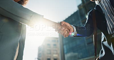 Outdoor, business people and professional with handshake, conversation and contract with lens flare, corporate and talk. Staff, employees in a city and coworkers with hello, partnership or urban town