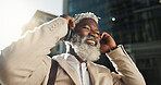 Happy, dancing and senior businessman with headphones in the city walking and listening to music. Smile, happy and elderly African male person streaming playlist, song or radio commuting in town.