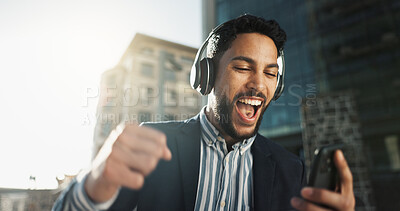 Happy, dance and businessman with headphones in city for job promotion celebration with phone. Smile, cellphone and excited professional young male person listening to music, radio or album in town.