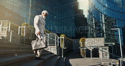 City, business and stairs with old man, walking and corporate with a briefcase, sunshine and buildings. Elderly person, employee and entrepreneur with urban town, steps and New York with professional