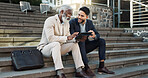 Tablet, conversation and business men in the city in discussion for corporate legal case. Teamwork, collaboration and male attorneys with digital technology sitting and talking on stairs in town.