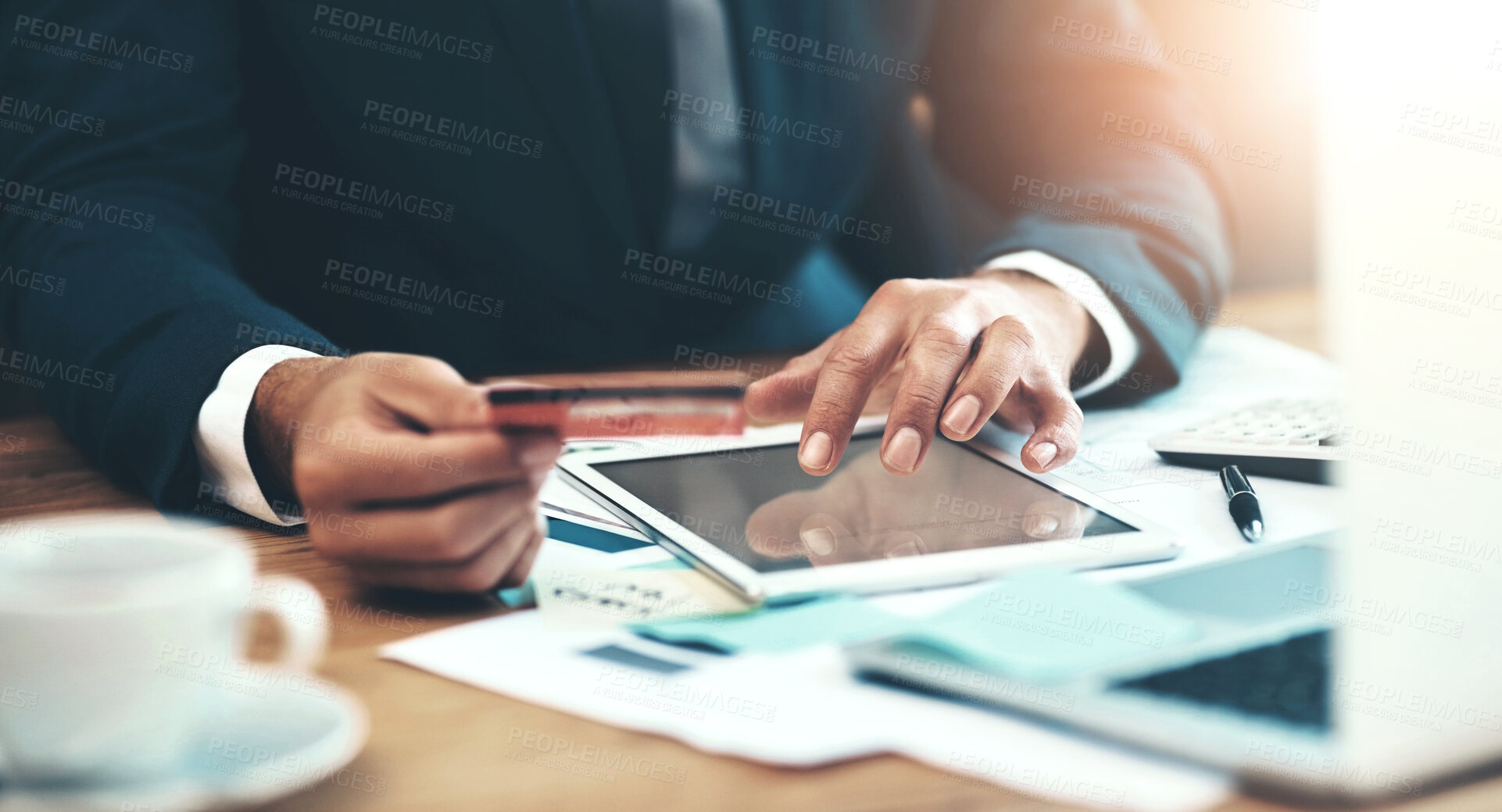 Buy stock photo Shot of an unidentifiable businessman making a credit card payment online