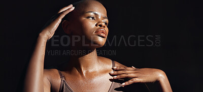 Face, vision and beauty with a natural black woman on a dark background in studio for feminine wellness. Hands, skincare and thinking with a young model touching her body or skin in satisfaction