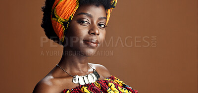 Culture, African fashion or face of black woman in studio on a brown background for trendy style. Unique, beauty or model with confidence, pride or afro posing in wrap, clothes or traditional outfit