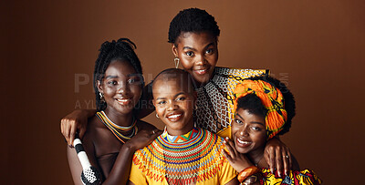 Fashion, beauty and heritage with group of black women in studio on brown background together for support. Portrait, smile and culture with happy African people in clothes of tradition for community