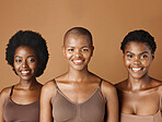 Face, skincare and natural with black woman friends in studio on a brown background for a wellness routine. Portrait, aesthetic and smile with a group of people looking happy at beauty treatment