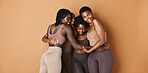 Hug, face or African models with skincare, glowing skin or results isolated on brown background. Facial dermatology, friends or natural beauty cosmetics in studio with black women or happy people