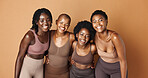 Laughing, face or African models with skincare, glowing skin or results isolated on brown background. Facial dermatology, friends hug or natural beauty in studio with black women or happy people