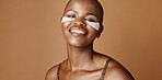 Skincare, health and face of black woman in studio with glowing, natural and facial routine. Smile, cosmetic and portrait of African person with dermatology beauty treatment by brown background.