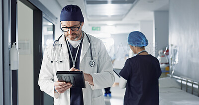 Surgeon, doctor and tablet for hospital, healthcare or clinic research, online planning and schedule management. Medical professional typing on digital technology for surgery results, charts or data