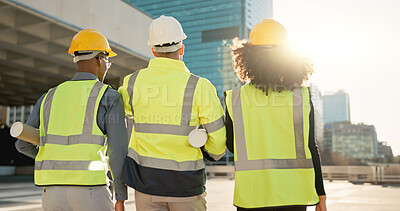 People, back and architect team walking in city for construction, maintenance or building on site. Rear view of employee group, engineer or contractor in teamwork for architecture project or plan