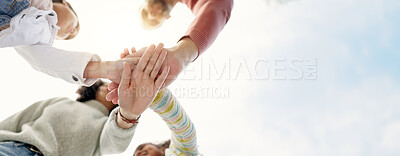 Family, hands together and team in solidarity below for collaboration or celebration under sky. Low angle of mother, father and kids piling for teamwork motivation, support or coordination together