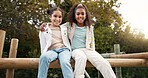 Friends, happy and children hug in park on jungle gym for bonding, childhood and having fun on playground. Friendship, outdoors and portrait of young girls embrace for playing, freedom and adventure