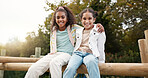 Friends, happy and children hug in park on jungle gym for bonding, childhood and having fun on playground. Friendship, outdoors and portrait of young girls embrace for playing, freedom and adventure