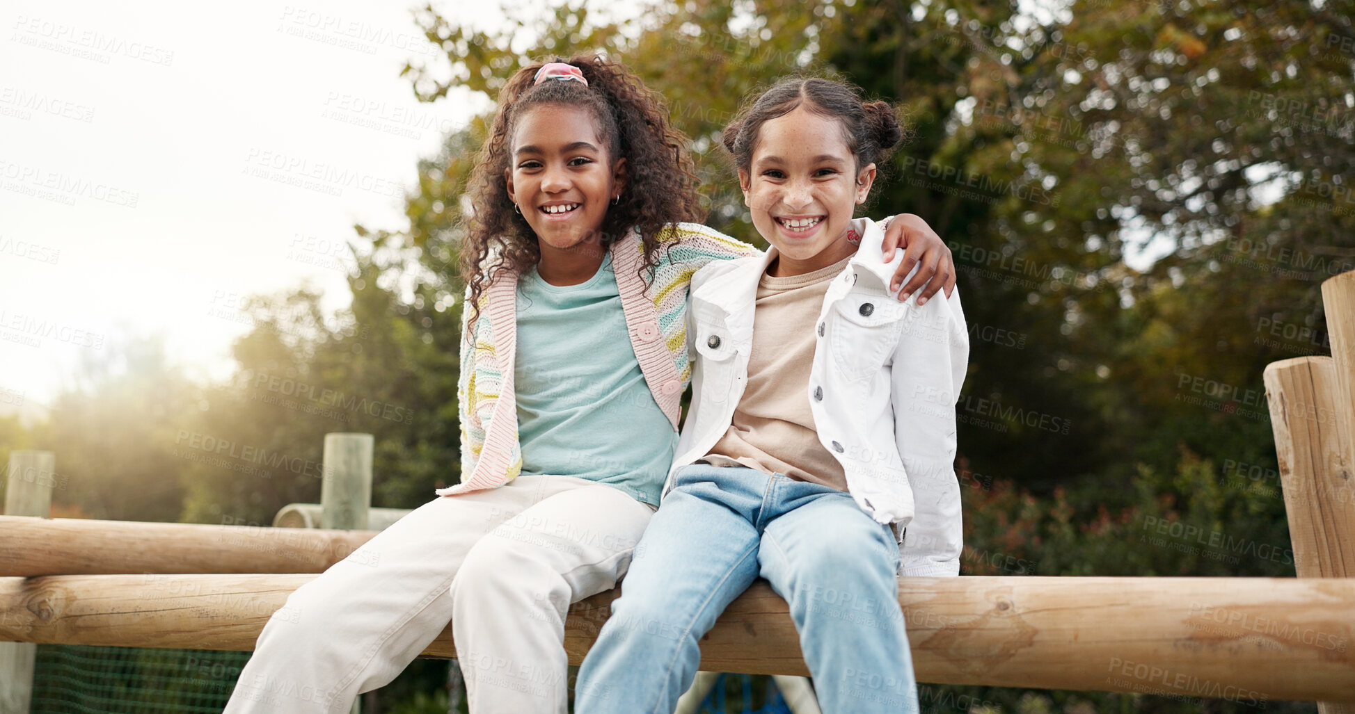 Buy stock photo Friends, happy and children hug in park on jungle gym for bonding, childhood and having fun on playground. Friendship, outdoors and portrait of young girls embrace for playing, freedom and adventure