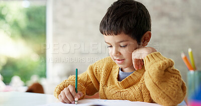 Child, drawing or boy writing homework on notebook in kindergarten education for growth development. Project, creative or young art student with color pencil learning or working on sketching skills