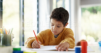 Student, drawing or boy writing homework on notebook in kindergarten education for growth development. Project, creative or young kid artist with color pencil learning or working on sketching skills
