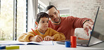 Father, boy child and homework with laptop, writing and helping hand for education, childhood development or care. Man, dad and male kid with home school, notebook and computer with teaching at desk