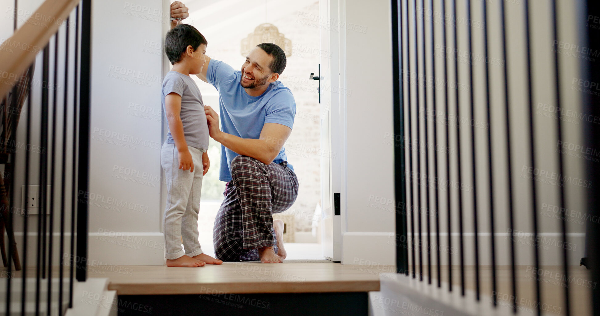 Buy stock photo Happy, measuring height and a father with a child writing growth progress on a home wall. Laughing, pride and a dad drawing results of a kid measurement in a house to check for growing together