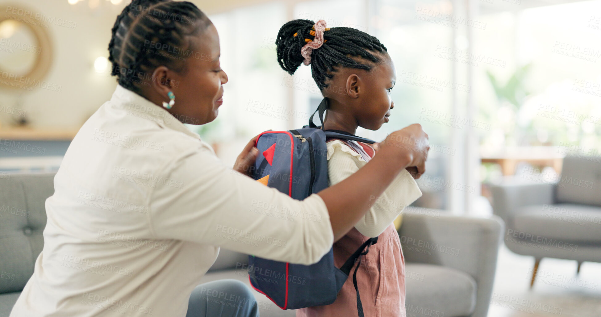 Buy stock photo Getting ready, morning and a mother with a child for school, leaving kiss and talking in the living room. Happy, speaking and an African mom helping a girl with a backpack in a house for kindergarten