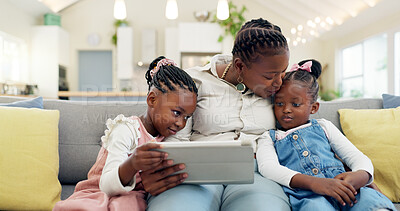 Happy, mother with her child and tablet on sofa in living room of their home together. Technology or connectivity, happiness or kissing and black family on couch streaming a movie in their house