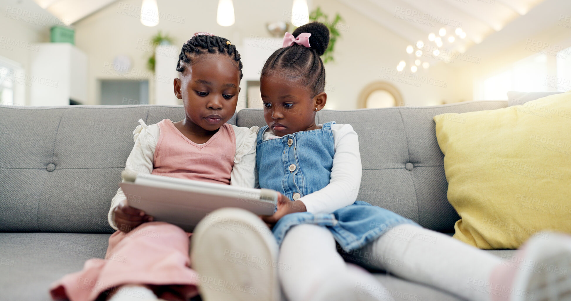 Buy stock photo Black girl children, tablet on sofa and online with elearning or watching cartoon movie, sisters at home and screen time. Young female kids, streaming and subscription to education app or film