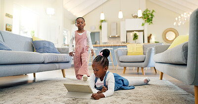 Black girl children on ground with tablet and relax, elearning or watch cartoon movie, sisters at home and screen time. Young female kids, streaming online and subscription to education app or film