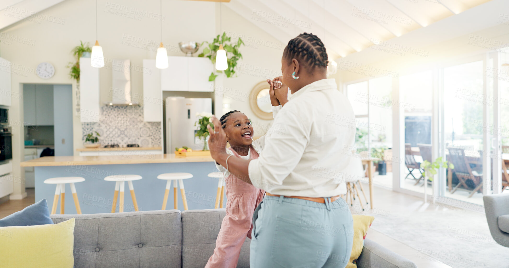 Buy stock photo Excited mom, child and dancing in living room with happiness, energy and bonding in home together. Black family, mother and daughter dance on sofa, music and quality time for woman and little girl.