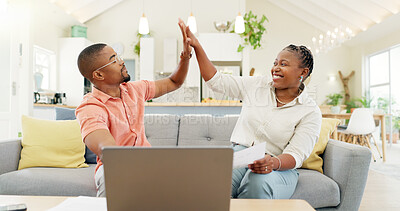 Technology, married couple celebrating and laptop on a sofa in living room of their home. Social media or online communication, success or high five and black people together happy for connectivity