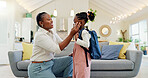 Talking, happy and a mother with a child getting ready for school in the morning. Kiss, laughing and an African mom helping a little girl with a bag in the living room of a house for kindergarten