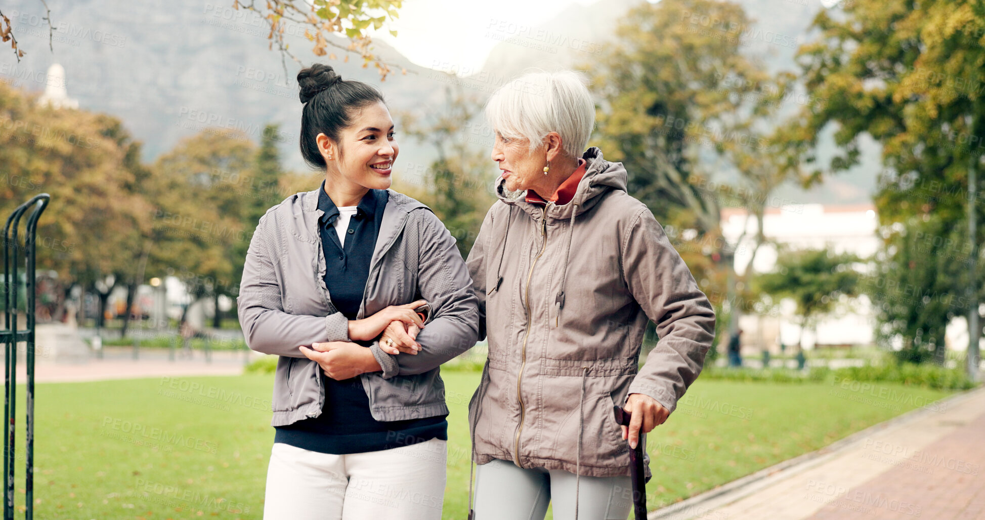 Buy stock photo Senior woman, walker and nurse talking in a park with healthcare for elderly exercise. Walking, healthcare professional and female person with peace and physical therapy in a public garden with carer