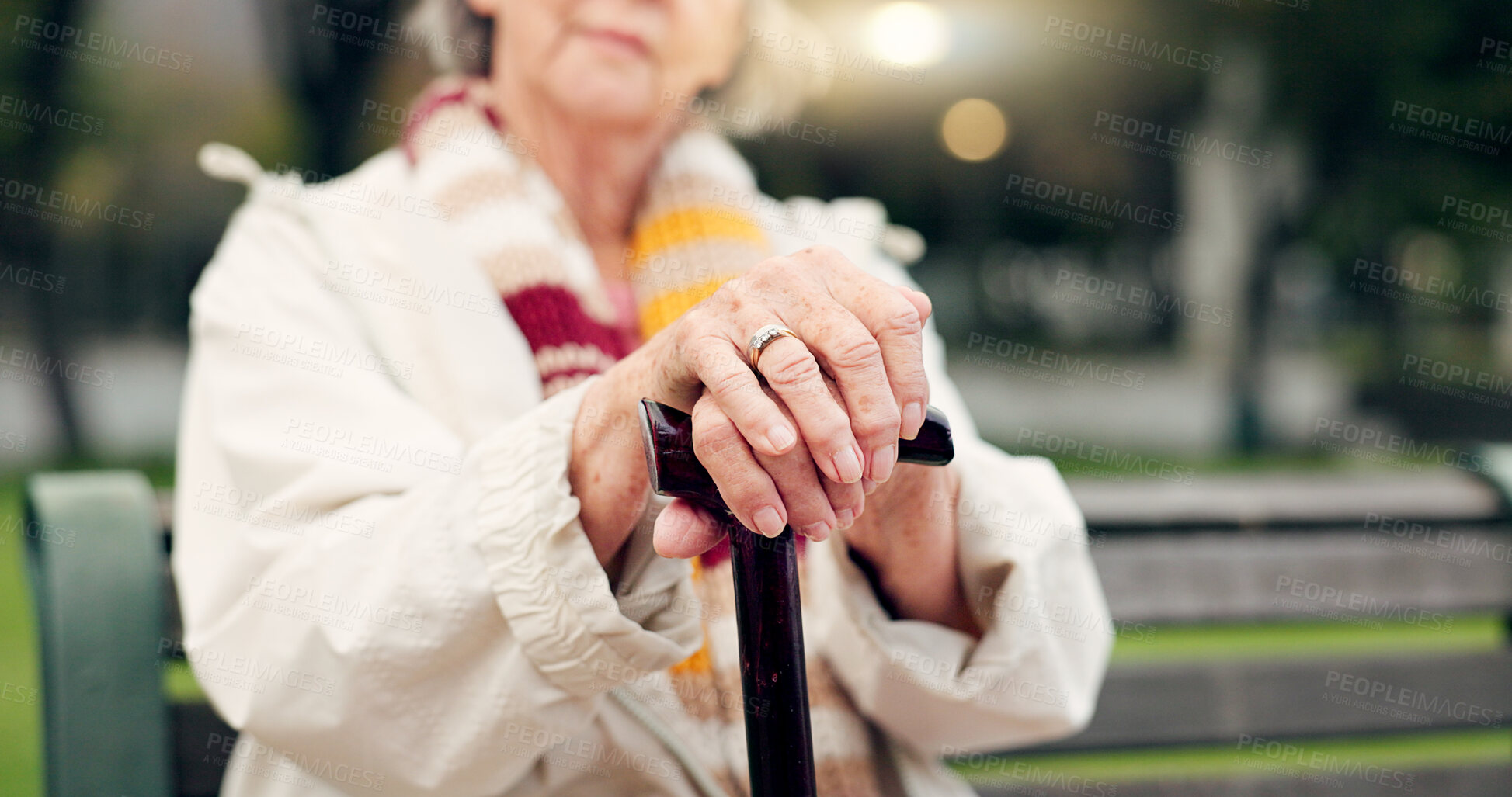 Buy stock photo Walking stick, hands and senior woman closeup on a park bench with person with disability. Mobility support, wellness and balance with cane and elderly female person outdoor in a public garden
