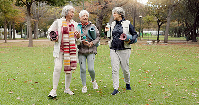 Senior friends, walking and talking with yoga mats in the park to relax in nature with elderly women in retirement. People, happy conversation and healthy outdoor exercise or pilates in winter